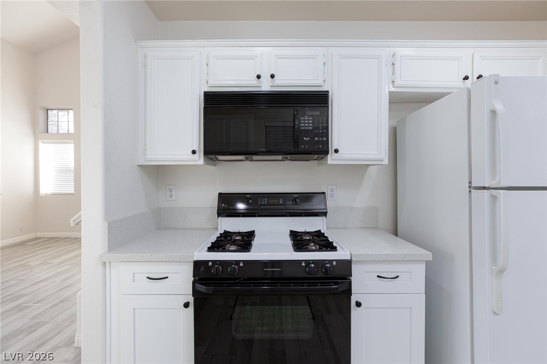 2246 Ramsgate Drive Henderson, NV 89074 - Photo 10 of 36 White cabinetry, solid countertops, and modern appliances make this a highly functional culinary space.