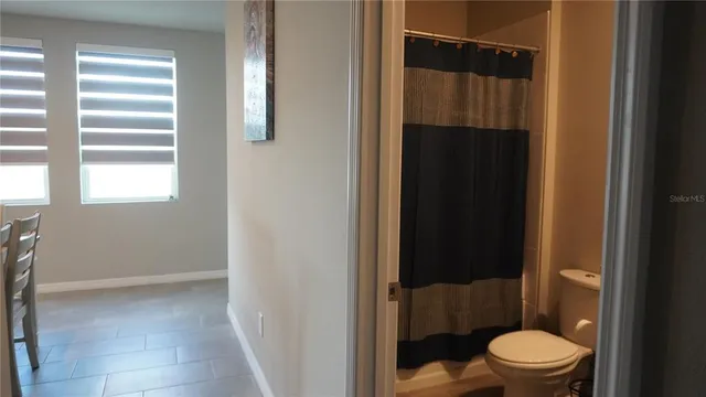 a bathroom with a toilet and a shower