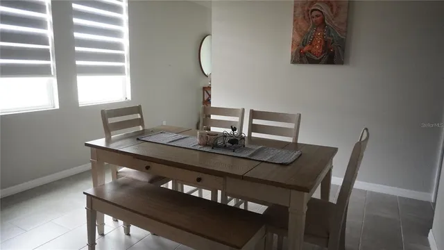 a view of a workspace with furniture and window