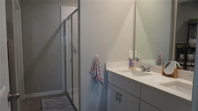 a bathroom with a double vanity sink and a mirror