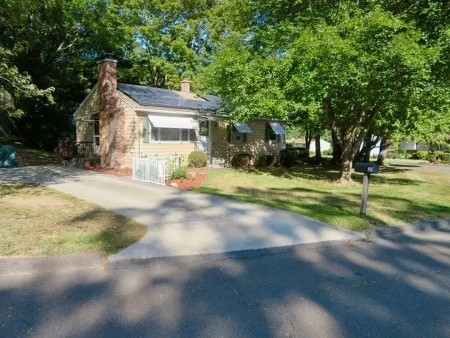 a view of a house with a yard and garage