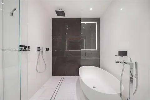 a bathroom with a shower sink and mirror