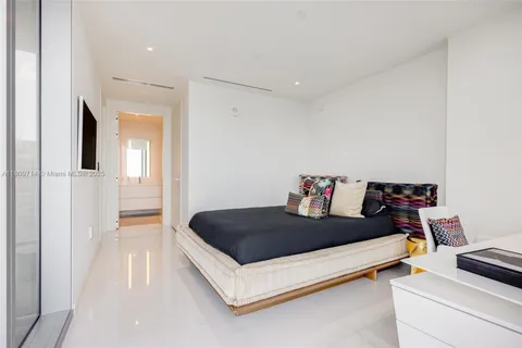 a room with a chair and white walls