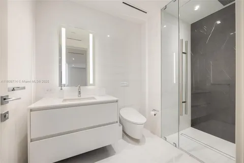 a bathroom with a sink toilet and mirror