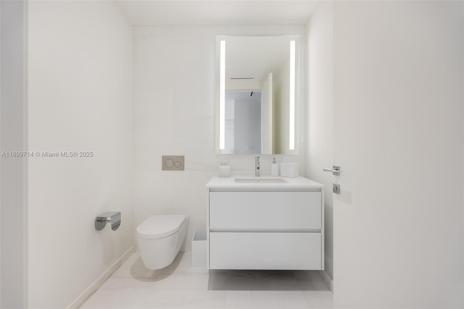 300 Biscayne Blvd Way, Unit 5205W Miami, FL 33131 - Photo 25 of 40 a bathroom with a sink toilet and mirror