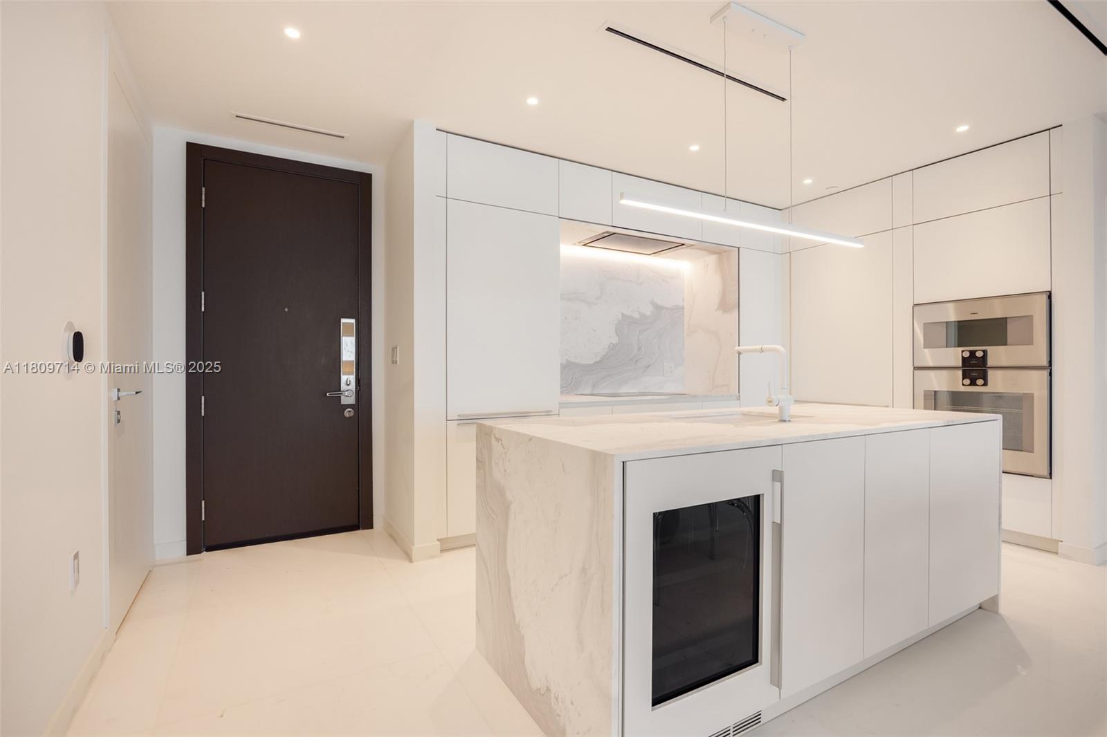 300 Biscayne Blvd Way, Unit 5205W Miami, FL 33131 - Photo 6 of 40 a view of kitchen with granite countertop cabinets and refrigerator