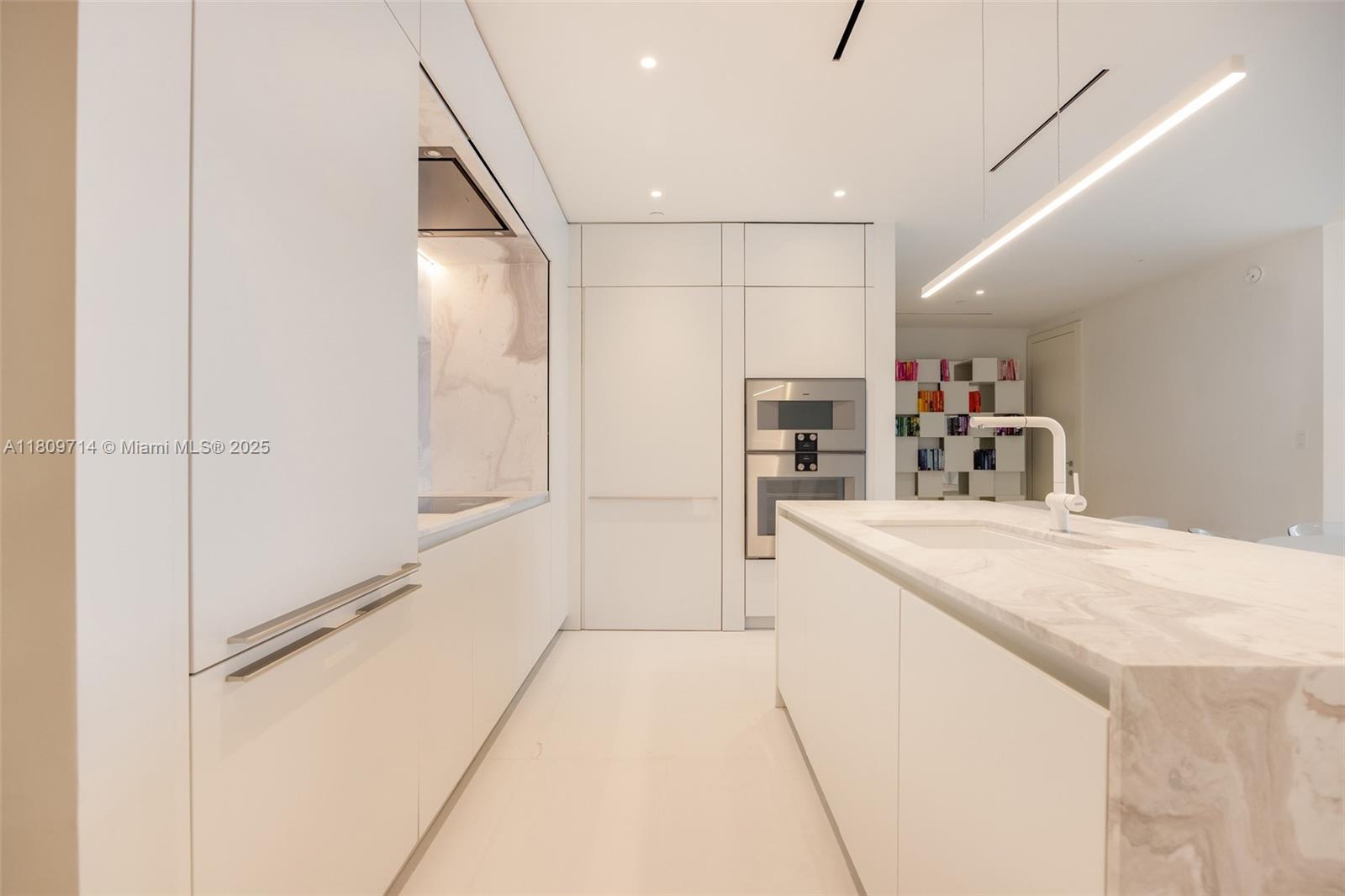 300 Biscayne Blvd Way, Unit 5205W Miami, FL 33131 - Photo 9 of 40 a kitchen with kitchen island a sink appliances and cabinets
