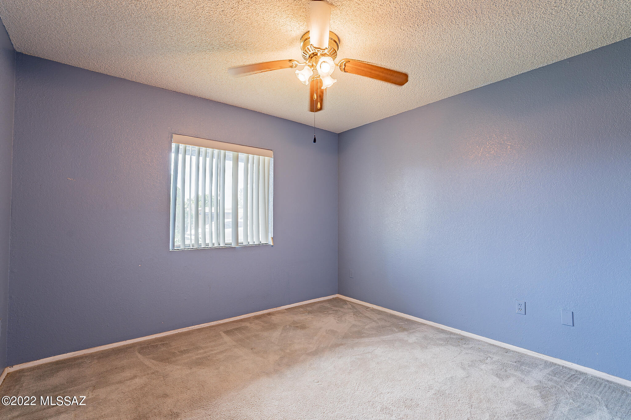 441 Sykes Circle Rio Rico, AZ 85648 - Photo 9 of 11 an empty room with windows and chandelier fan