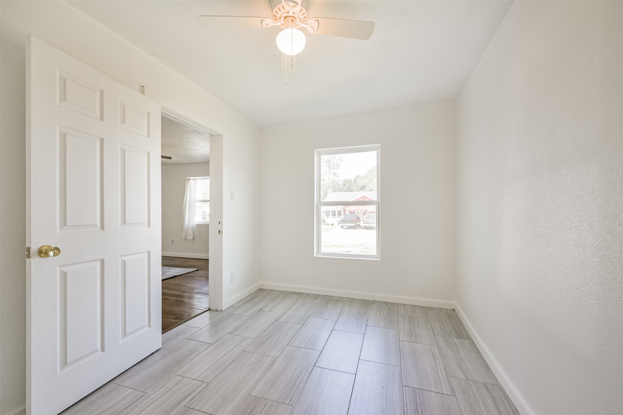 7546 Greendowns Street Houston, TX 77087 - Photo 27 of 33 an empty room with wooden floor and windows