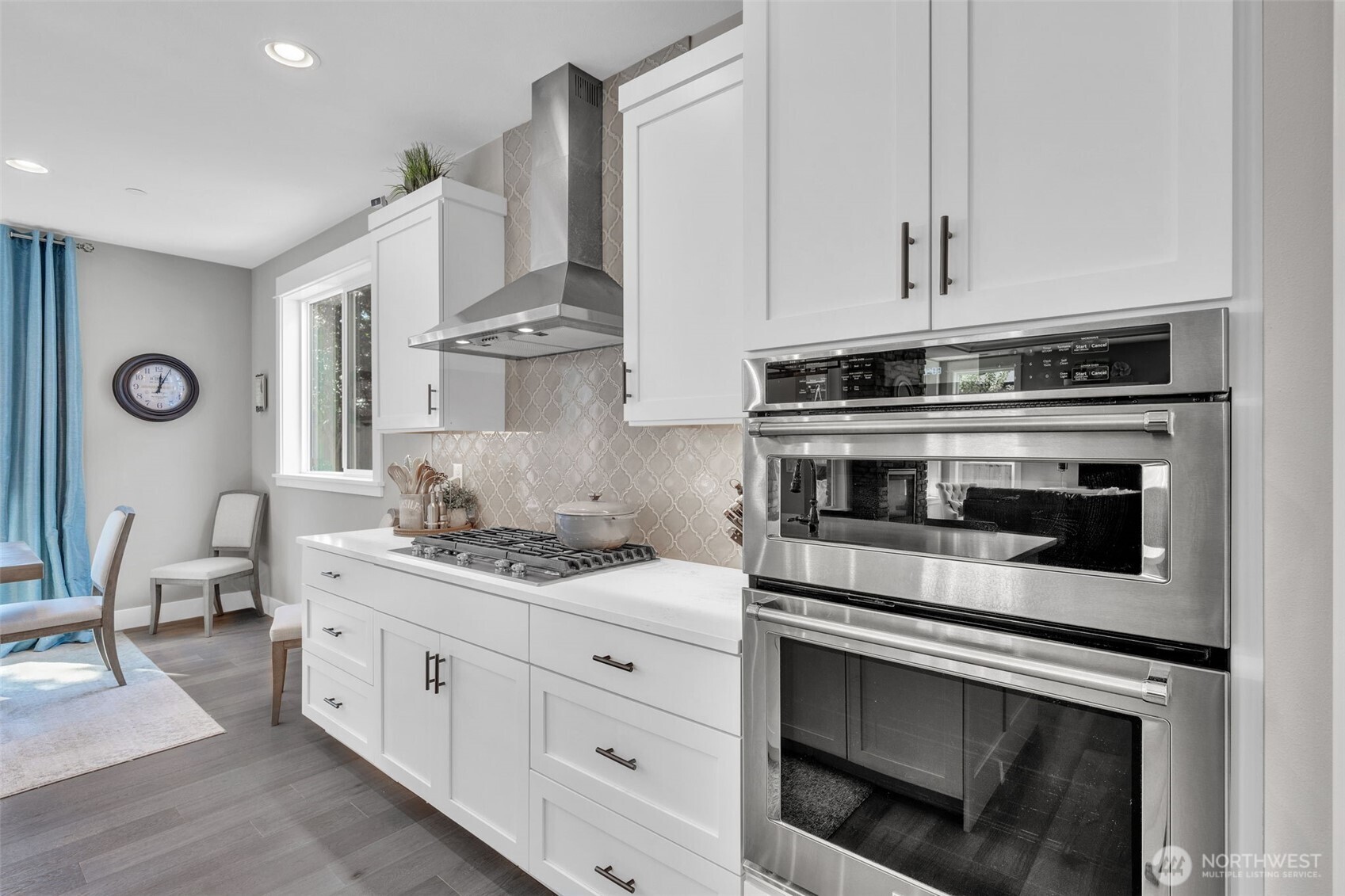 23216 9th Avenue Southeast Bothell, WA 98021 - Photo 9 of 40 a kitchen with stainless steel appliances white cabinets and a stove top oven