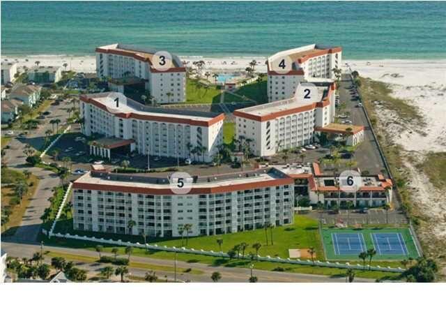 a view of building with yard and outdoor seating