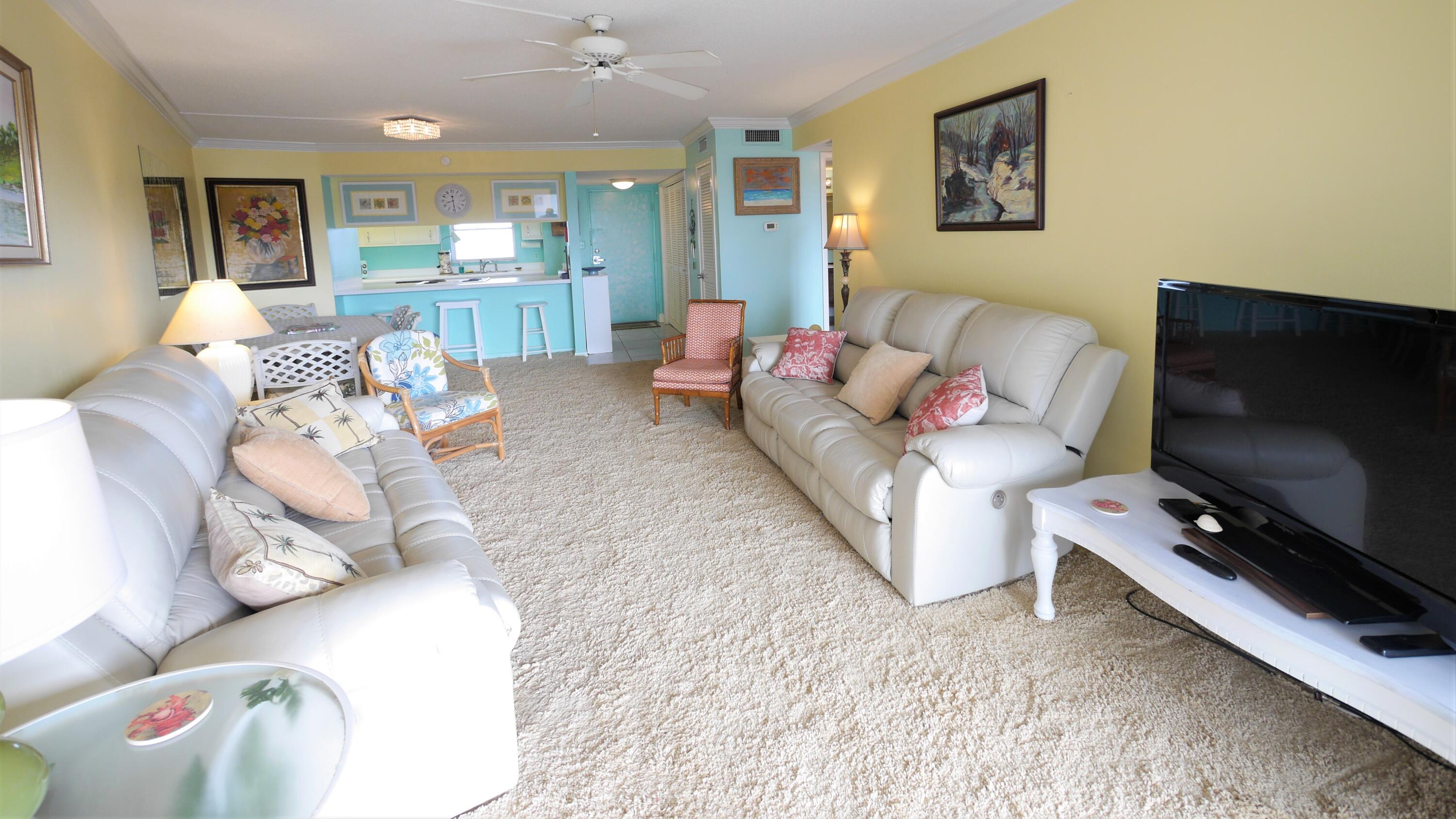 909 Santa Rosa Boulevard, Unit 265 Fort Walton Beach, FL 32548 - Photo 6 of 18 a living room with furniture and a flat screen tv