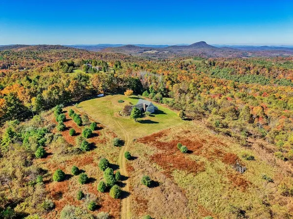 a living room with furniture fireplace and a large window