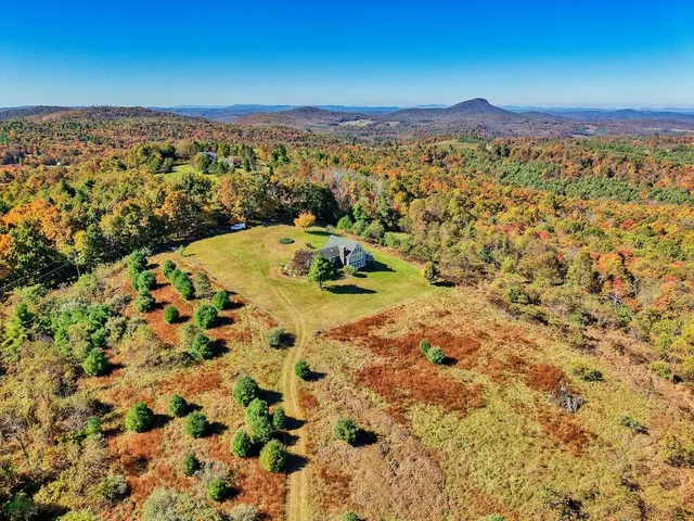 a living room with furniture fireplace and a large window