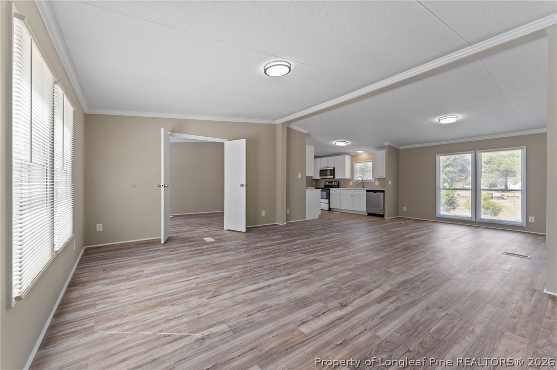515 Mt Zion Road Red Springs, NC 28377 - Photo 14 of 50 an empty room with wooden floor and windows