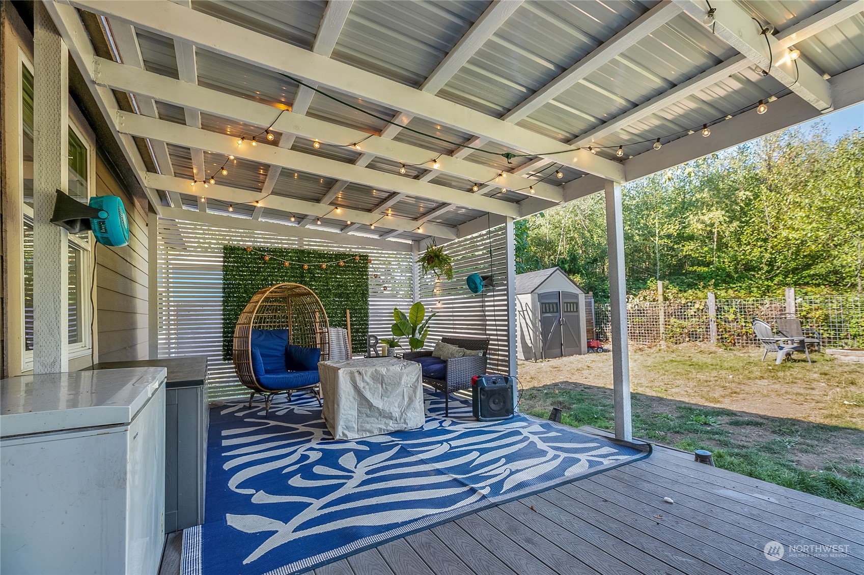 4599 Decatur Drive Ferndale, WA 98248 - Photo 15 of 18 a view of a patio with table and chairs potted plants with wooden floor and fence