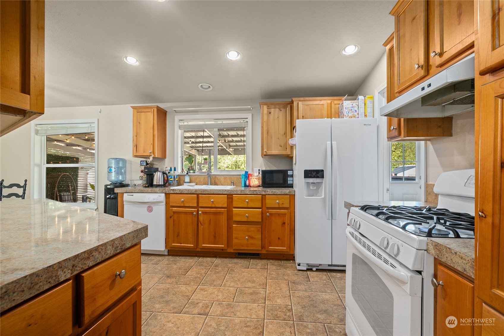 4599 Decatur Drive Ferndale, WA 98248 - Photo 3 of 18 a kitchen with stainless steel appliances granite countertop a stove a sink a refrigerator and white cabinets