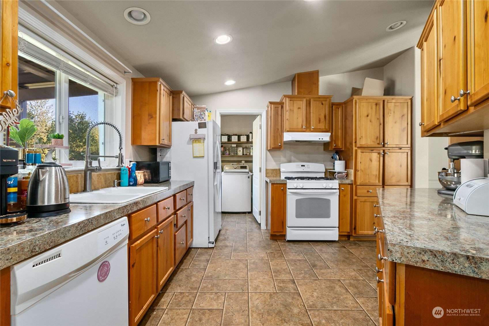 4599 Decatur Drive Ferndale, WA 98248 - Photo 6 of 18 a kitchen with stainless steel appliances granite countertop a stove a sink and a refrigerator