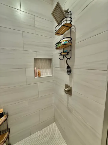 a bathroom with a toilet and a mirror