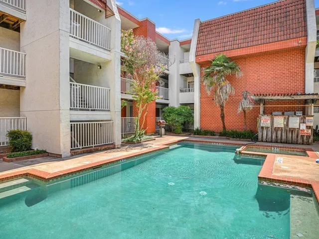 a view of backyard with a tub and wooden fence
