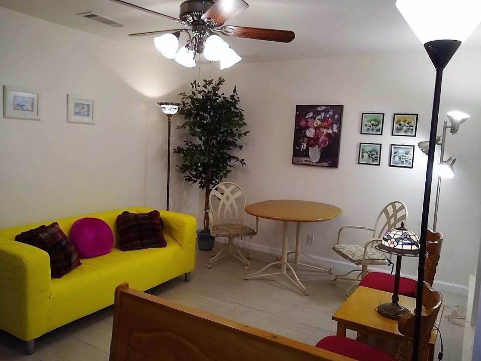3115 Helms Street, Unit 308 Austin, TX 78705 - Photo 2 of 14 a living room with furniture and a potted plant