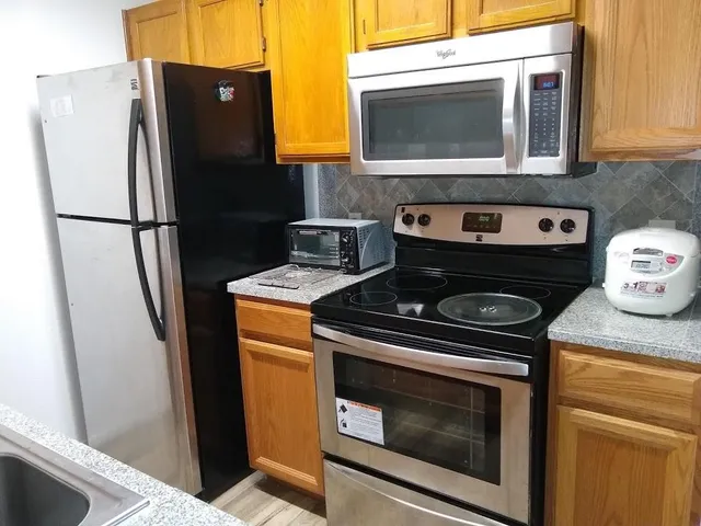 a stove top oven sitting inside of a kitchen