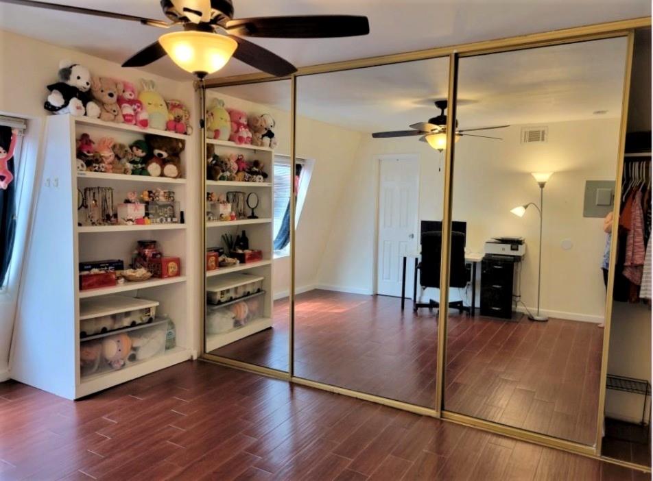 3115 Helms Street, Unit 308 Austin, TX 78705 - Photo 8 of 14 a view of a room with shelves and wooden floor
