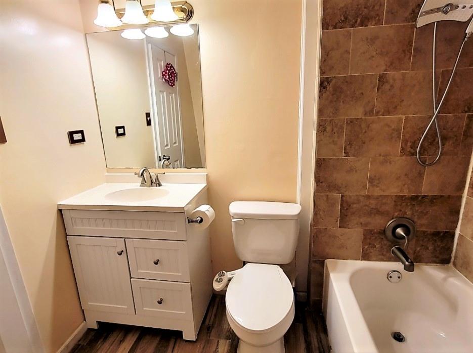 3115 Helms Street, Unit 308 Austin, TX 78705 - Photo 9 of 14 a bathroom with a sink a toilet and shower
