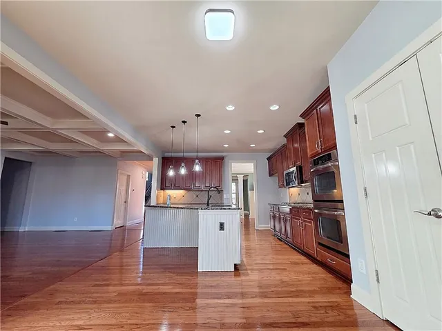 a view of kitchen with cabinets and wooden floor