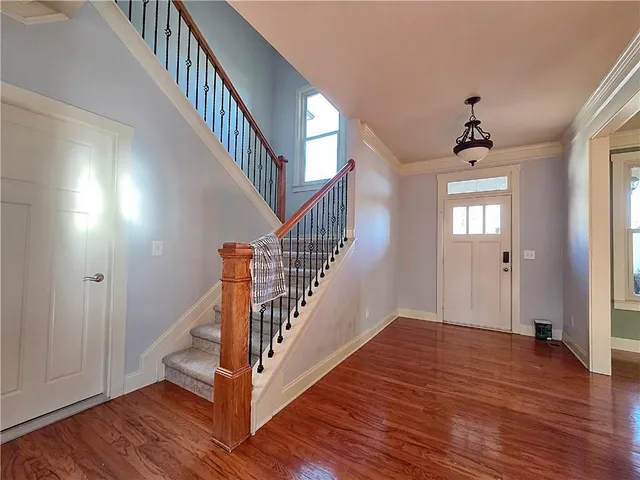 a view of entryway and hall with wooden floor