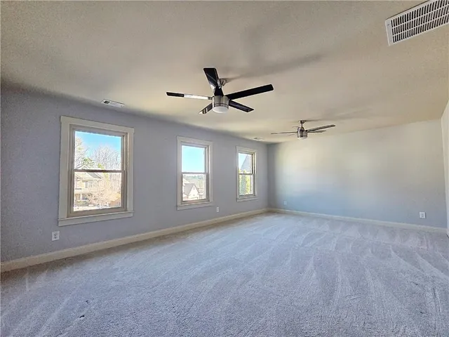 a view of a livingroom with a ceiling fan and window
