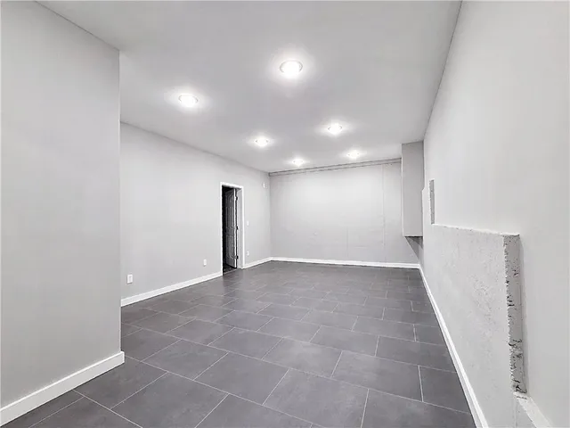 an empty room with windows and entrance