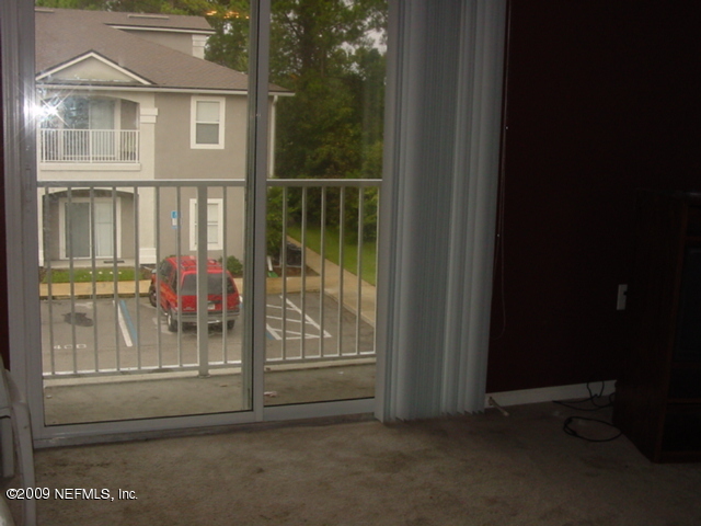 7920 Merrill Road, Unit 2015 Jacksonville, FL 32277 - Photo 4 of 5 a view of a brick house with a small yard