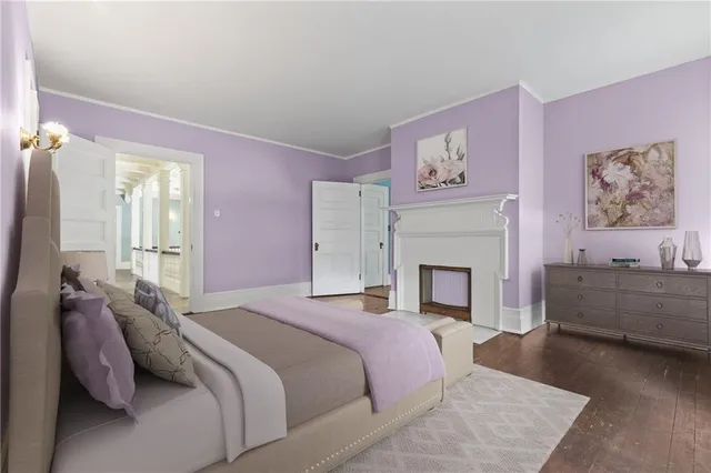 a spacious bedroom with a bed and a fireplace