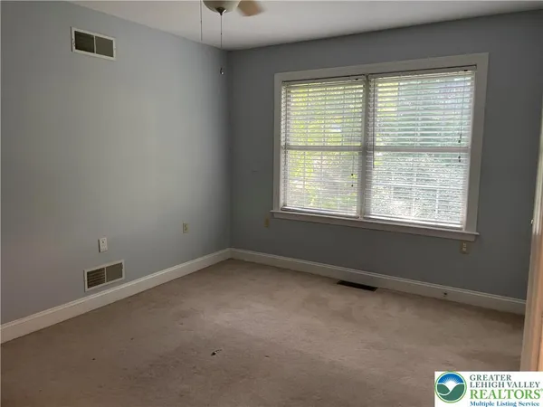 a bathroom with a shower a toilet and a sink
