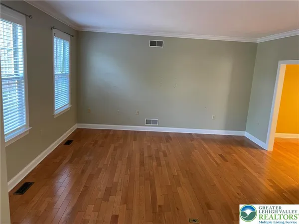 a view of room with window and wooden floor