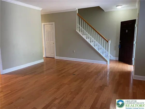 a view of an entryway with wooden floor