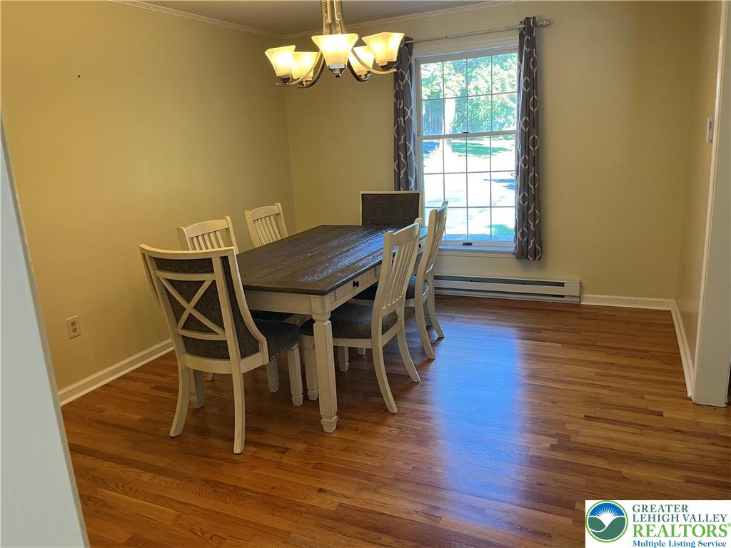 6221 Dove Drive Bethlehem, PA 18017 - Photo 17 of 38 Rich hardwood flooring complements a classic dining area illuminated by a traditional light fixture.