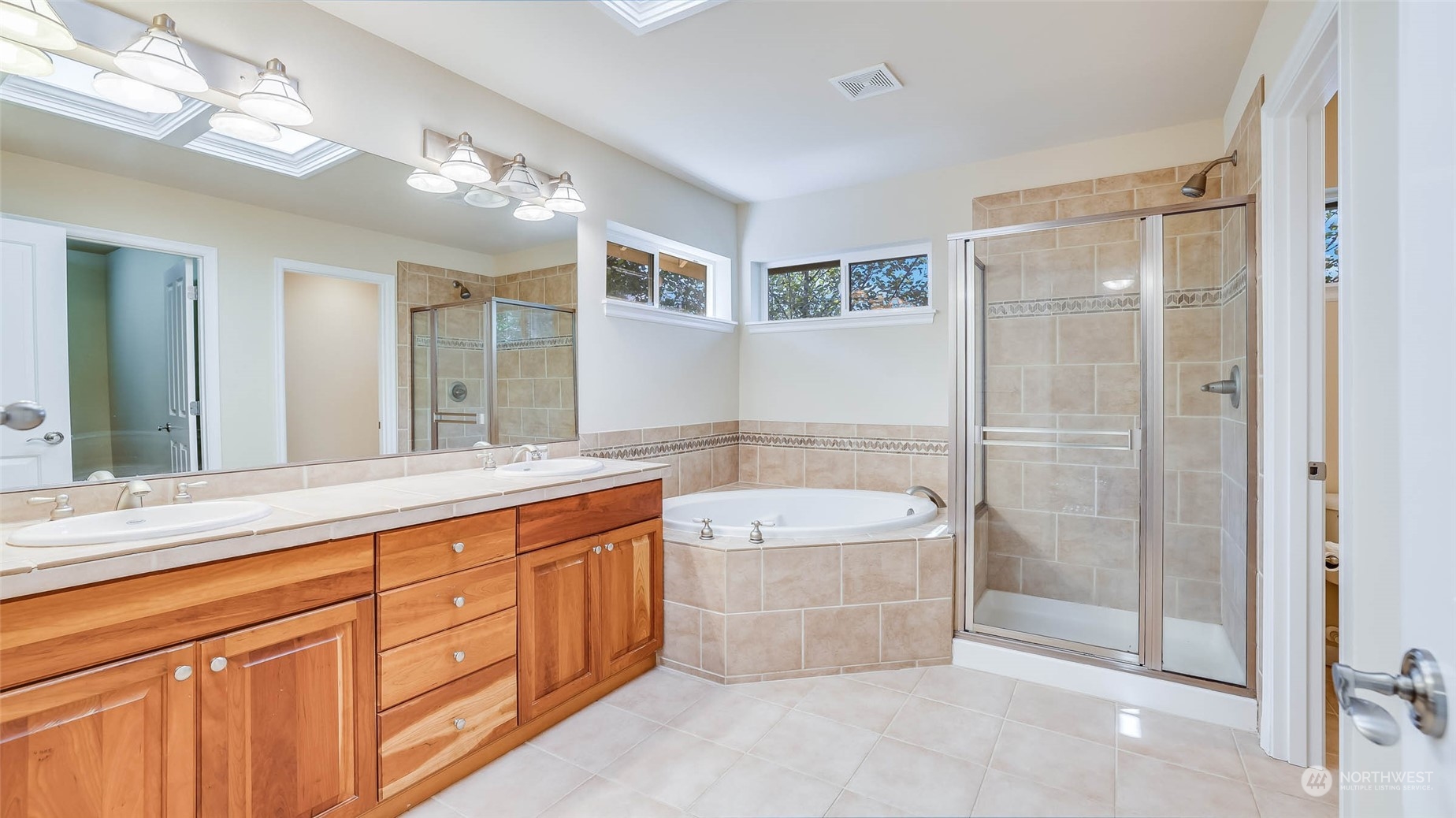 16601 Southeast 165th Way Renton, WA 98058 - Photo 19 of 33 a spacious bathroom with a tub sink mirror and shower