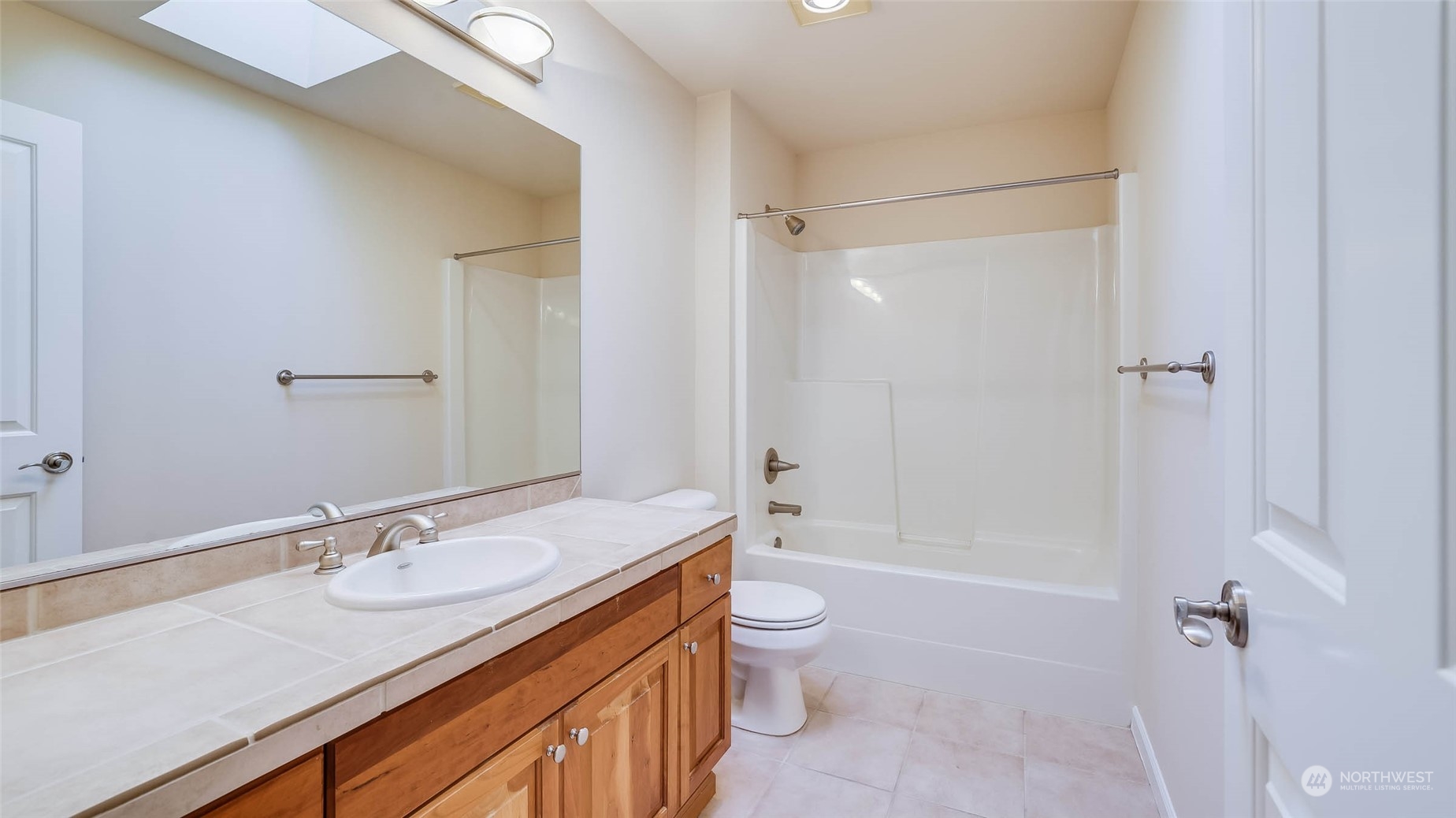 16601 Southeast 165th Way Renton, WA 98058 - Photo 23 of 33 a bathroom with a granite countertop sink mirror toilet and bathtub