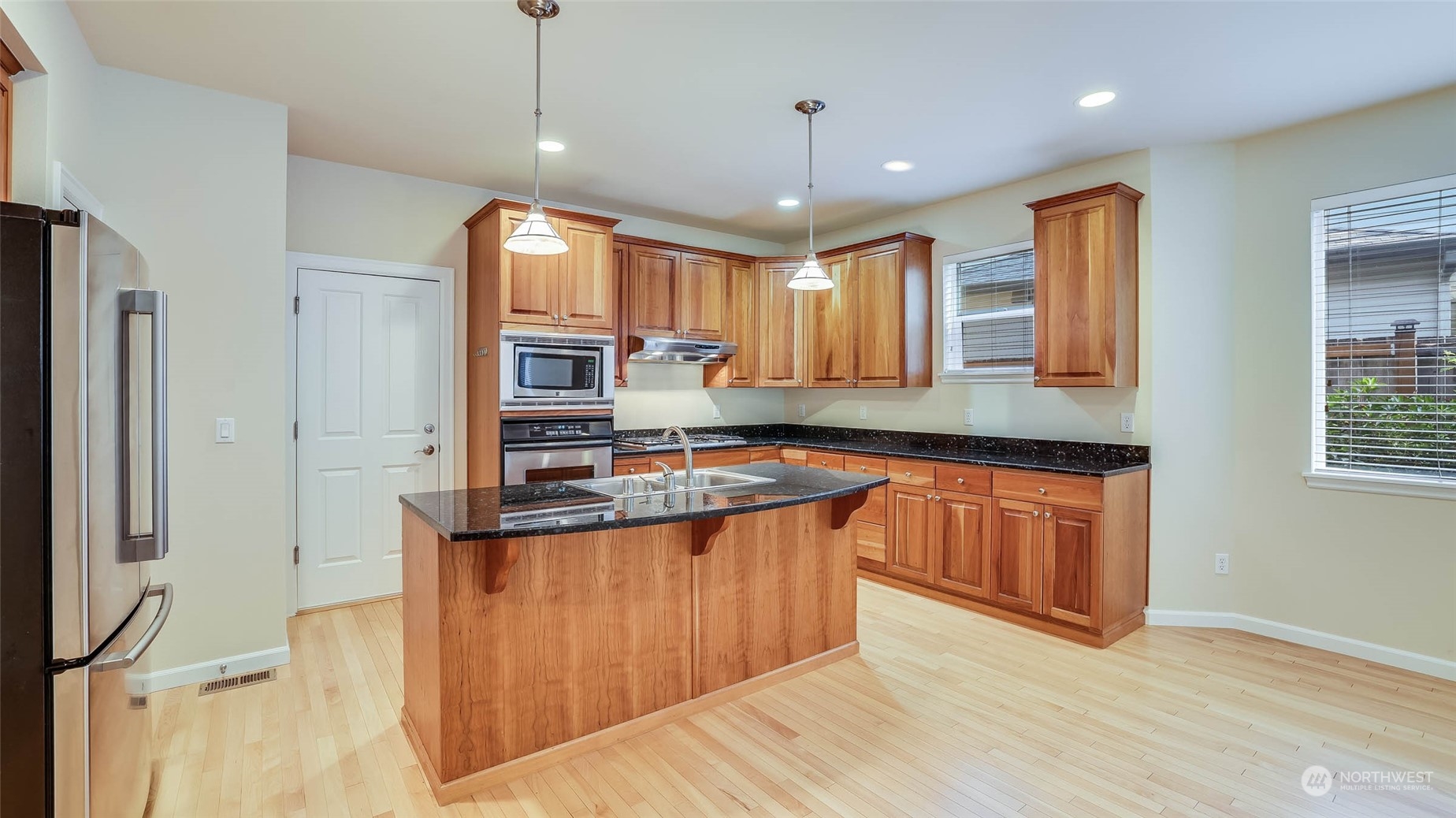 16601 Southeast 165th Way Renton, WA 98058 - Photo 5 of 33 a large kitchen with stainless steel appliances granite countertop a stove a sink and a refrigerator