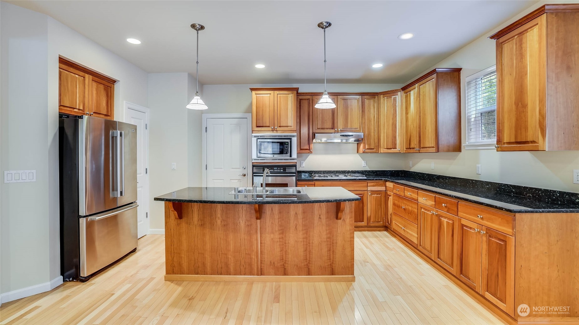 16601 Southeast 165th Way Renton, WA 98058 - Photo 6 of 33 a large kitchen with stainless steel appliances granite countertop a refrigerator a sink dishwasher a stove and white countertops with wooden floor
