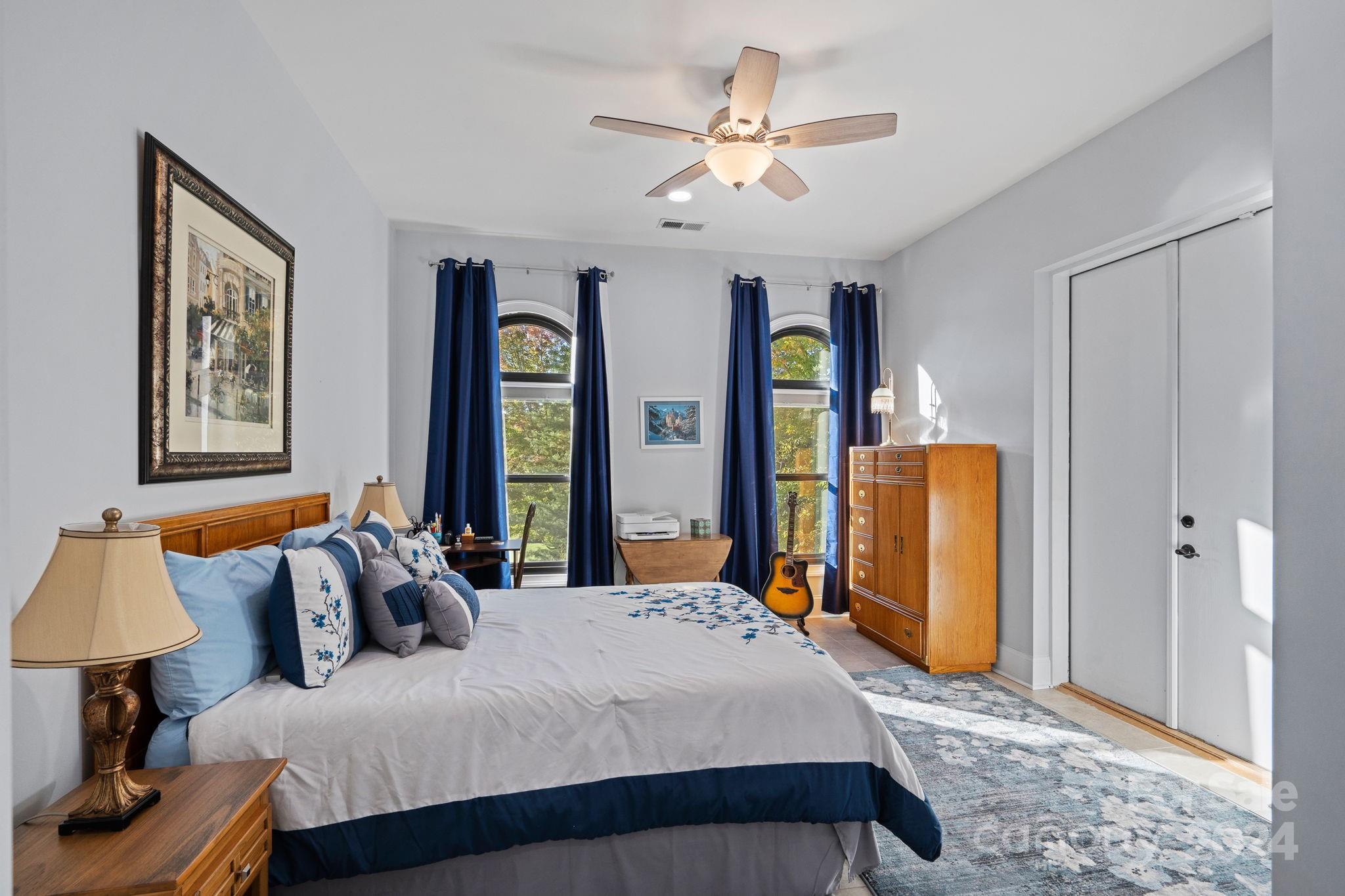719 Old Cove Road Fort Mill, SC 29708 - Photo 35 of 45 a bedroom with a large bed and a chandelier
