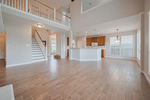 a view of a kitchen with furniture and wooden floor