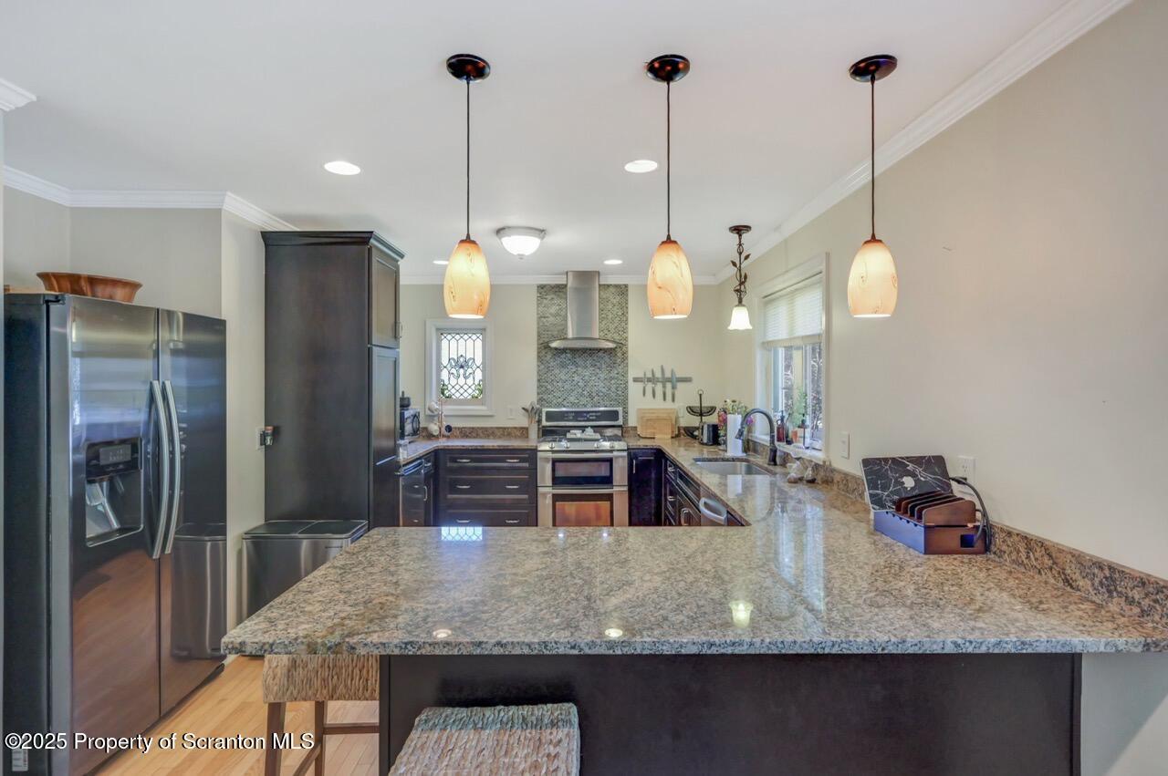 109 Upper Knapp Road, Unit L34 Clarks Summit, PA 18411 - Photo 12 of 39 a kitchen with kitchen island a counter and refrigerator