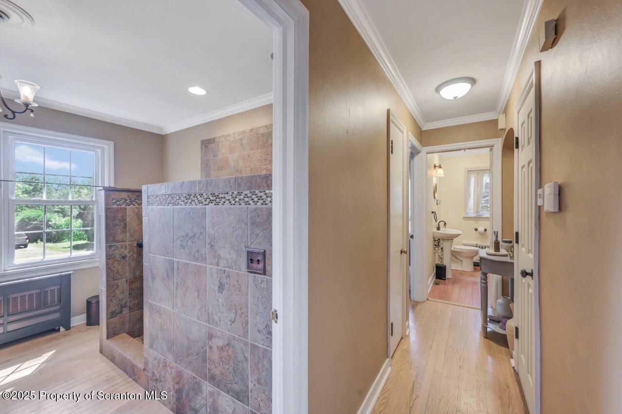 109 Upper Knapp Road, Unit L34 Clarks Summit, PA 18411 - Photo 20 of 39 a bathroom with a glass shower door a sink and a mirror