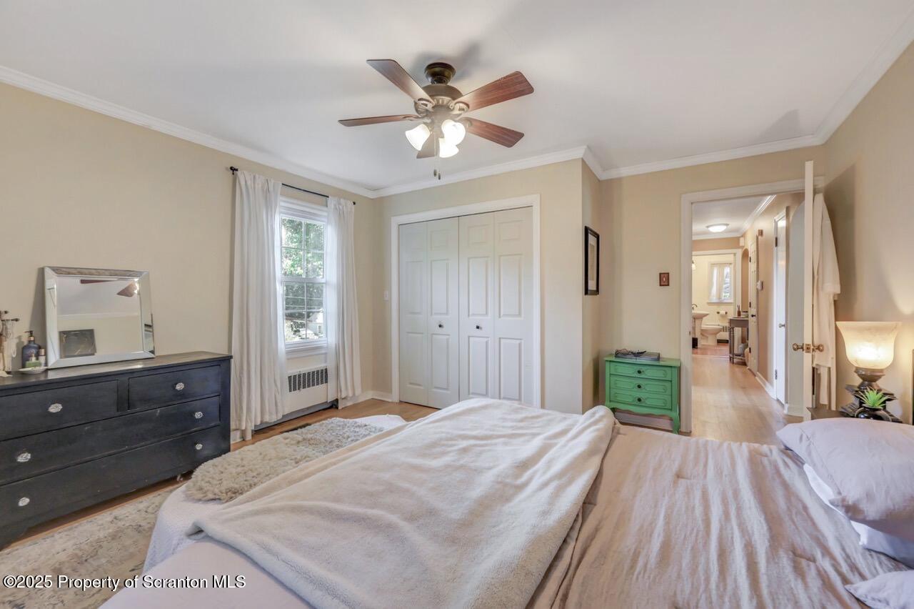 109 Upper Knapp Road, Unit L34 Clarks Summit, PA 18411 - Photo 26 of 39 a bedroom with a large bed and a chandelier