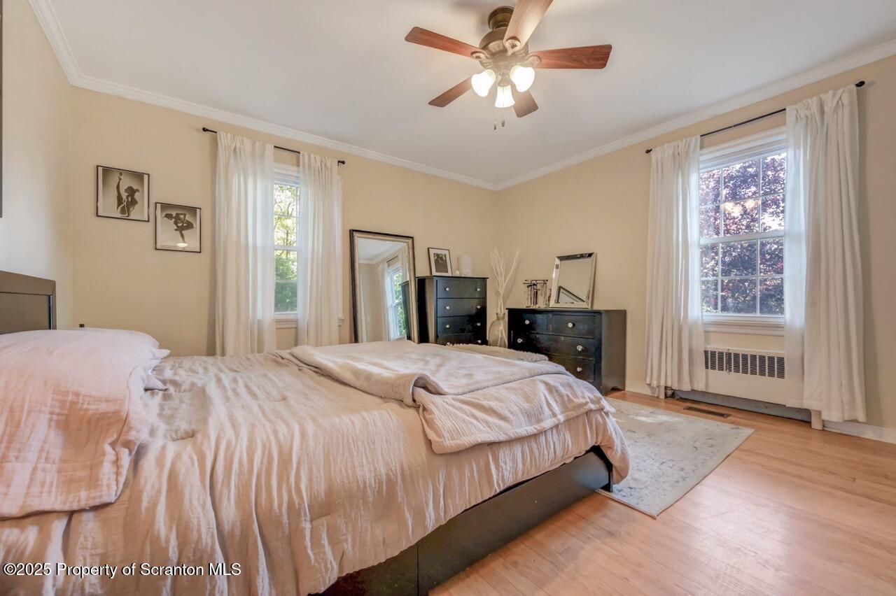 109 Upper Knapp Road, Unit L34 Clarks Summit, PA 18411 - Photo 27 of 39 a bedroom with a large bed and a chandelier