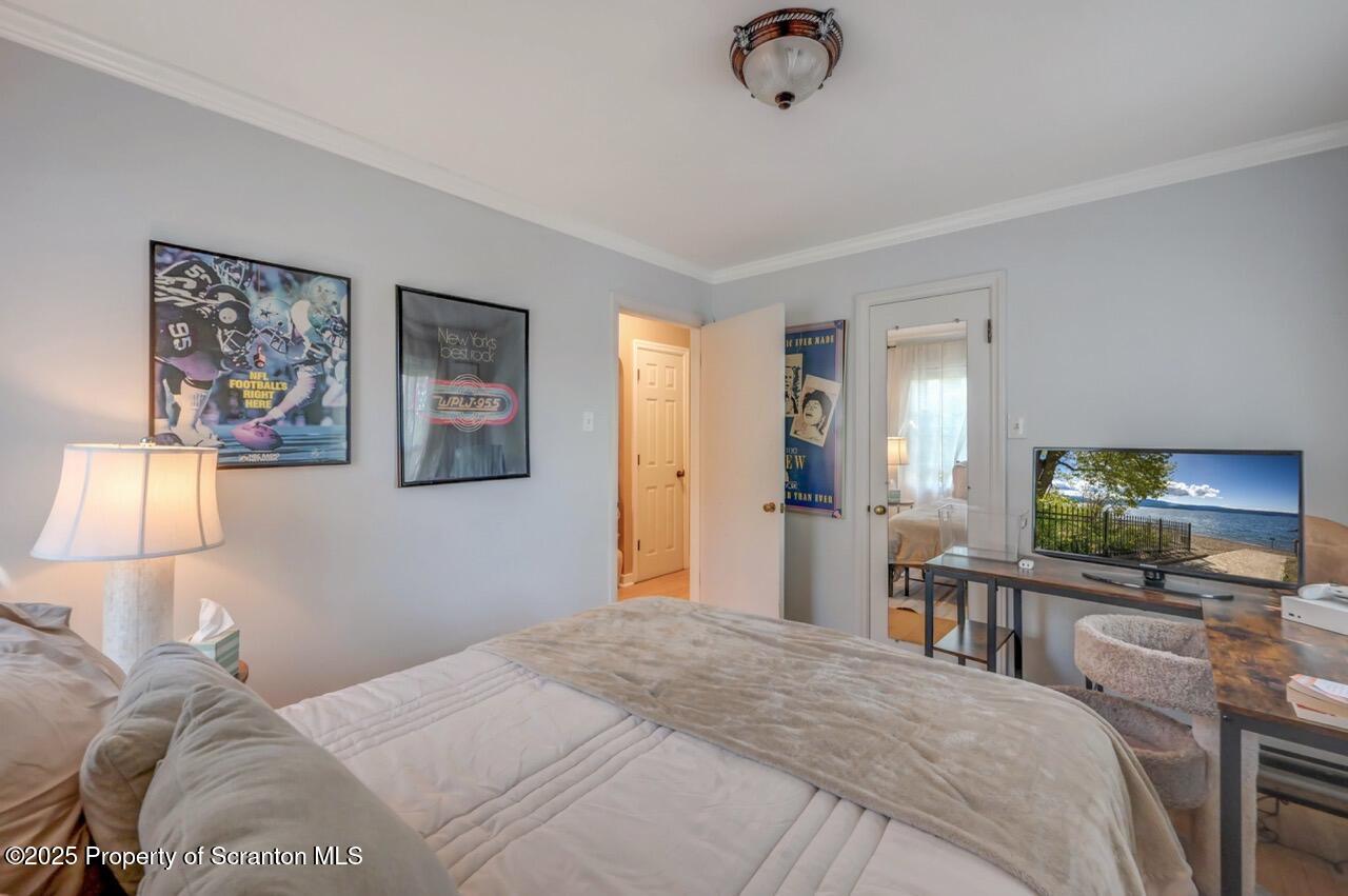 109 Upper Knapp Road, Unit L34 Clarks Summit, PA 18411 - Photo 31 of 39 a bedroom with a bed and a flat screen tv