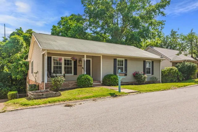 front view of a house next to a yard